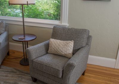 gray chair next to lamp