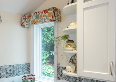 built-in white kitchen shelves and window