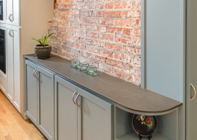 exposed brick wall and sky blue cabinets