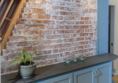 exposed brick and plant in 1940s portland kitchen